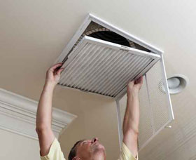 person replacing air filter