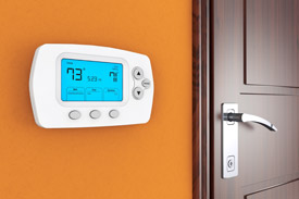 thermostat on orange wall