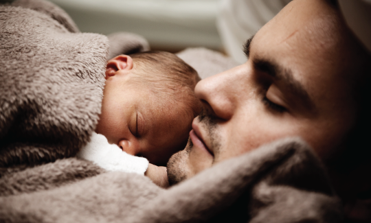 father and baby sleeping